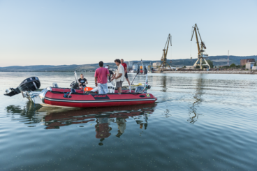 [Translate to Englisch:] boat with scientists at work for the project Solutions